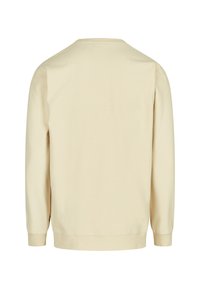 Cream-colored cotton sweatshirt, long sleeves, relaxed fit, ribbed cuffs and hem, soft texture, no visible graphics or designs.