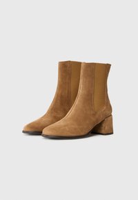Brown suede ankle boots with rounded toe, elastic side panels, and a block heel. Smooth texture and subtle sheen on the fabric.