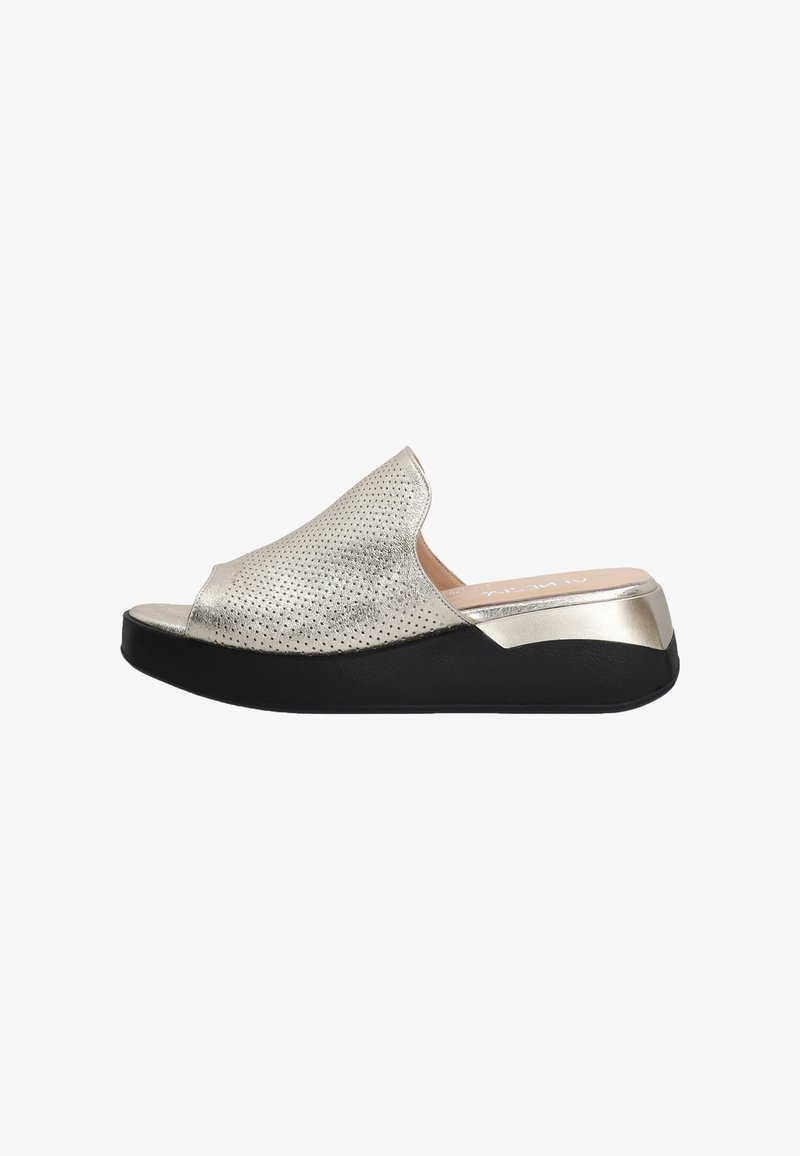 Metallic silver slip-on sandals with perforated texture, open toe design, and a black wedge sole. Accented with metallic detailing at the heel.