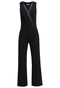Combinaison noire sans manches avec jambes larges, col en V profond et bordure diagonale en sequins le long de l'encolure et du corsage.
