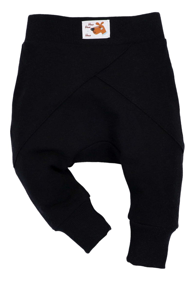 Mustat puuvillaiset vauvan housut, joissa on ristiin menevä muotoilu ja joustava vyötärö. Yläosassa on etiketti ruskealla koira-illustraatiolla.