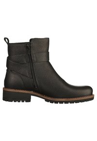 Bottes noires chevilles en cuir texturé, avec une fermeture éclair latérale et une semelle marron robuste, légèrement surélevée, avec un motif de crampons.