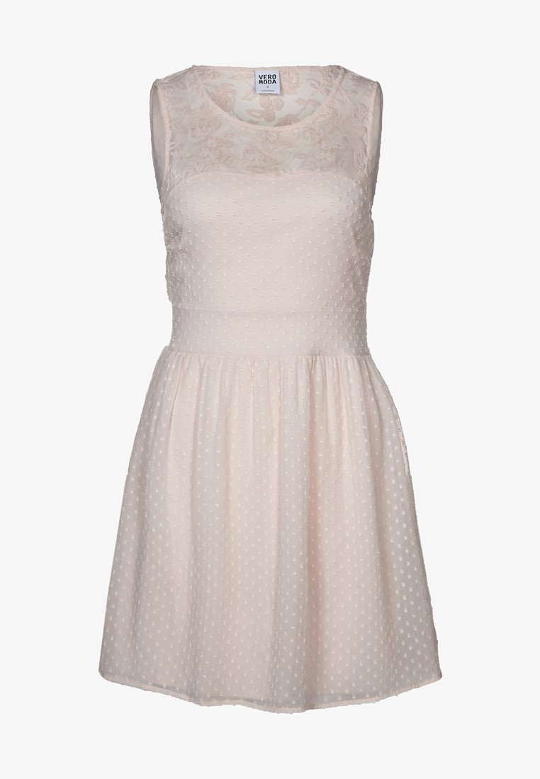 Ljusrosa ärmlös klänning med en texturerad polka dot-bodice och ett blommigt spetsöverlägg på toppen. Utsvängd kjol med rynkad midja.