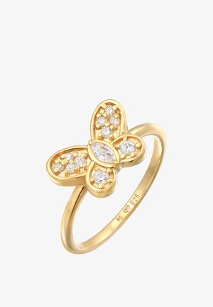 Gul sommerfugleformet ring med fire kronblade, prydet med klare krystaller. Glat ring med producentens gravering indeni.