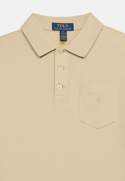 Μπεζ πόλο πουκάμισο Polo Ralph Lauren με τρία κουμπιά, γιακά, τσέπη στο στήθος και διακριτικό κεντητό λογότυπο στην τσέπη.