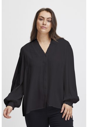 Schwarze, leichte Bluse mit V-Ausschnitt, Knopfverschluss und Falten-Details. Hat lange, gepuffte Ärmel mit gerafften Bündchen.