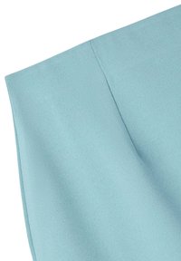 Tessuto blu chiaro con una superficie liscia e una leggera lucentezza, che mostra una sezione piegata e cuciture pulite lungo il bordo.