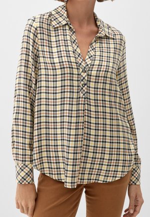 Camisa de botones de manga larga en un patrón de cuadros amarillo, marrón y negro, con cuello y dobladillo curvado.