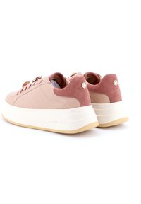 Sneaker in pelle rosa con accenti in camoscio, lati testurizzati, suola platform bianca e accessori decorativi. Include un logo sul tallone.
