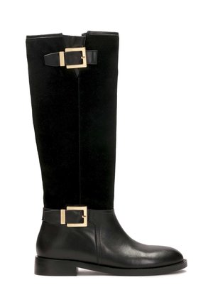 Knee-high black boots featuring a smooth leather lower section and a soft suede upper, accented with gold-tone buckle hardware.