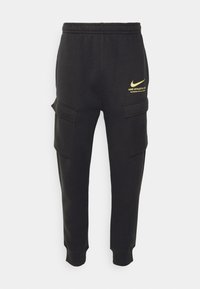 Svarta sweatpants i mjukt tyg, med elastiskt midjeband och två fickor i cargo-stil. Guld Nike-logotyp och textdetalj på övre lår.
