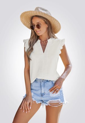 White, ruffled-sleeve blouse with a V-neck and decorative texture, paired with distressed light blue denim shorts. Accessories include round sunglasses and a straw hat.