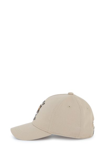 Casquette de baseball beige avec un visière incurvée. Décorée d'un motif de tigre brodé et de texte à l'avant. Fabriquée en tissu texturé avec un à l'arrière réglable.