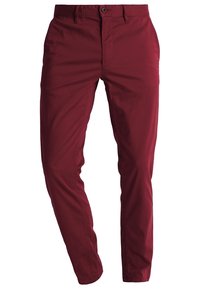 Burgunderröda bomullshängselbyxor med slim fit, utrustade med dragkedja och knappstängning, sidofickor och slät textur.