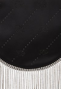 Black satin handbag with crystal embellishments and fringe detail. Smooth texture, round shape, and patterned surface with shiny accents.