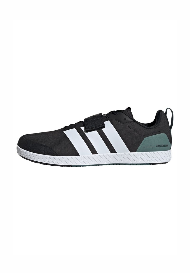 Black athletic shoe with a textured upper, three white stripes, a velcro strap, and a green accent on the heel. Features a rubber sole.