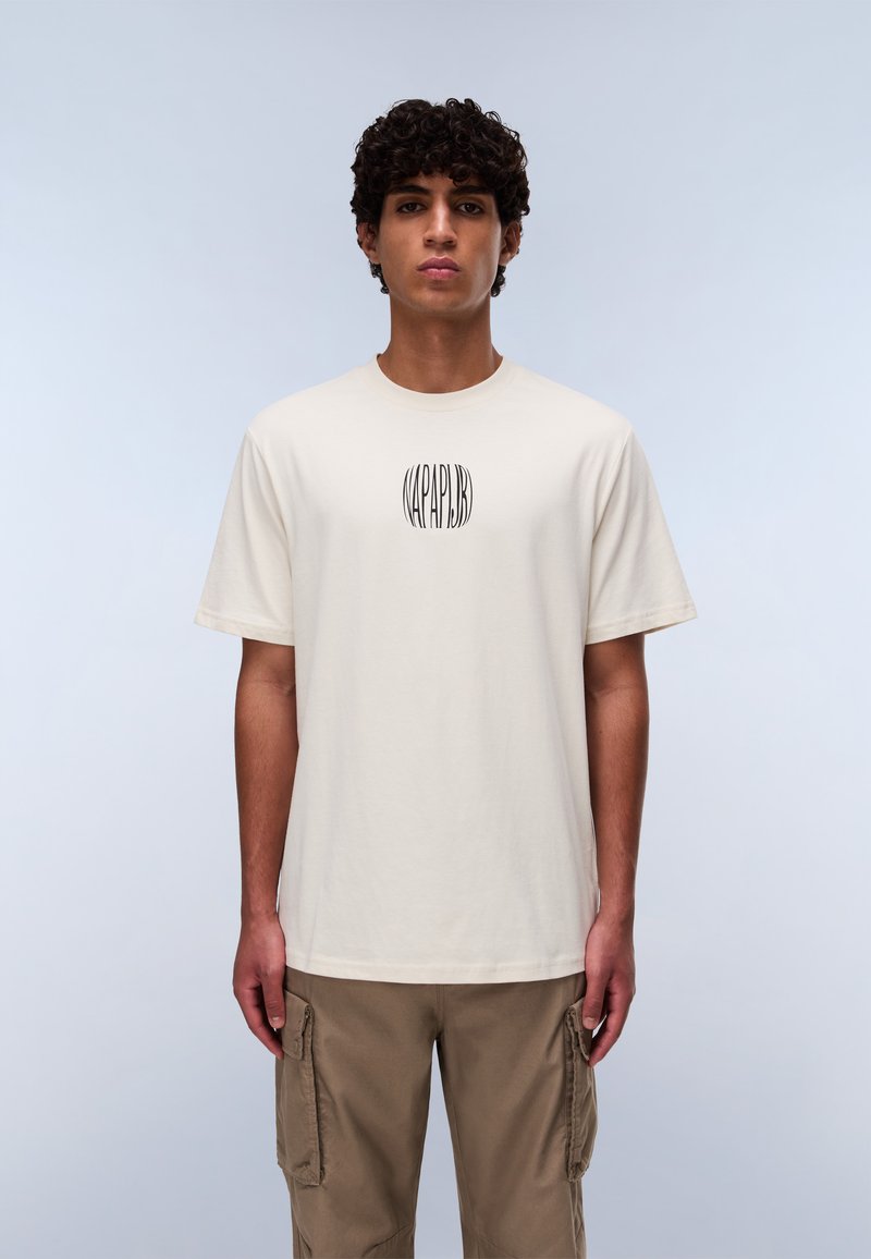 Cream-colored cotton t-shirt with a round neckline, short sleeves, and a central logo design in black. Casual fit with a soft texture.
