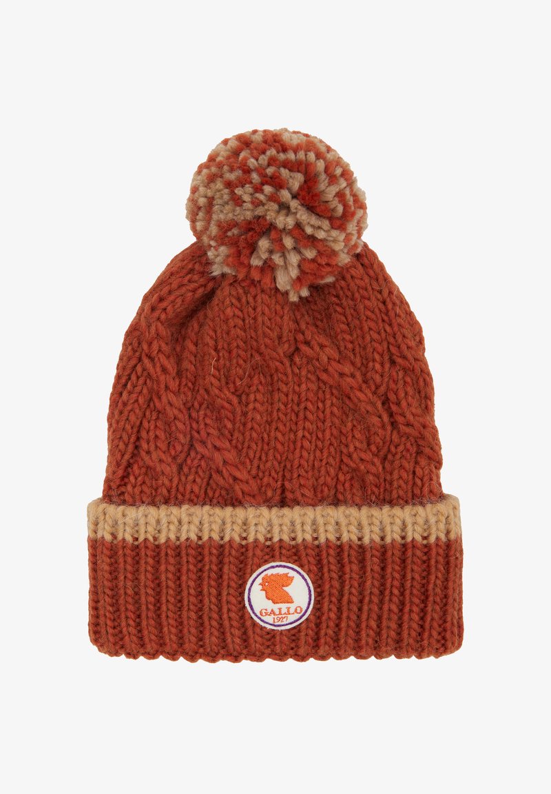 Knit beanie in orange and beige wool, featuring a cable pattern, a fold-over brim, and a pom-pom on top with a logo badge.