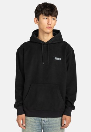 Felpa nera in fleece con tasca a marsupio, cappuccio regolabile con cordino e una piccola etichetta con logo sul petto. Texture morbida, vestibilità rilassata.