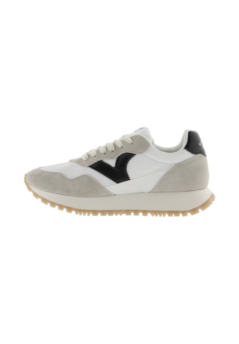 Sneakers with a white leather upper, gray suede accents, black logo, and gum rubber sole. Features round laces and a padded collar.