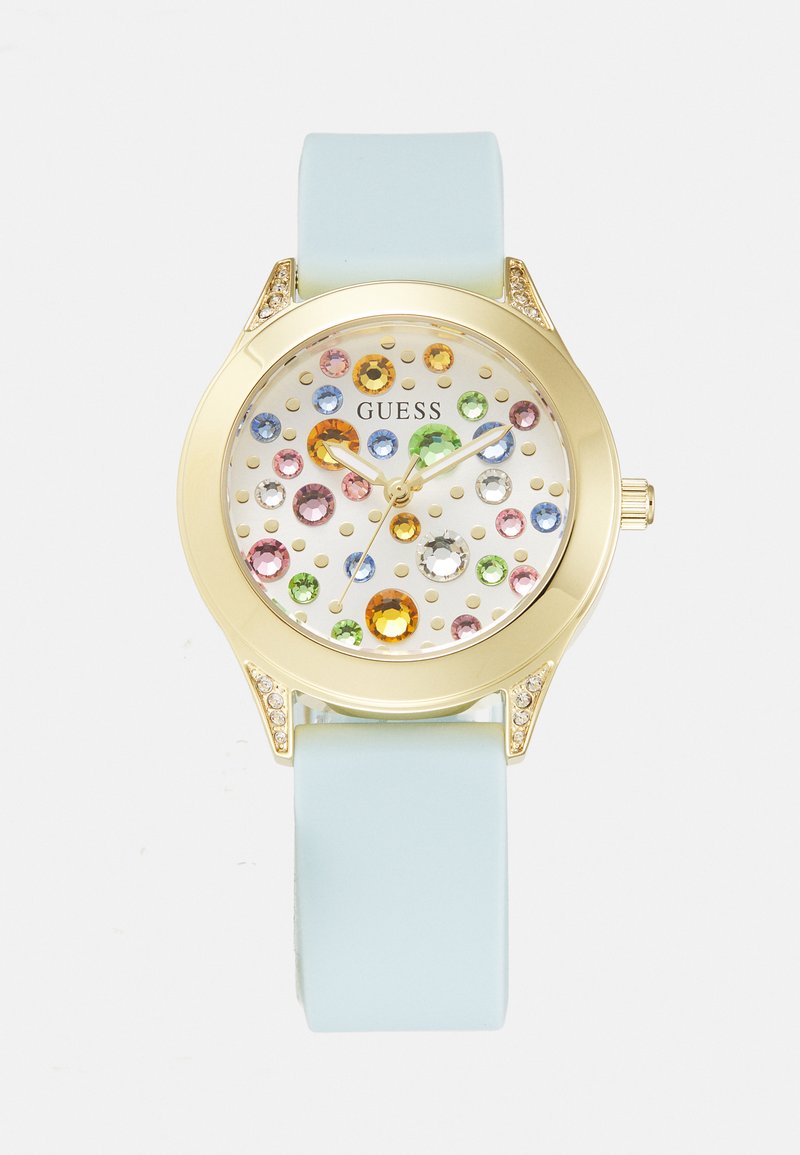 Reloj en tono dorado con una esfera blanca que presenta brillantes de colores, manecillas verdes y azules, y una correa de silicona de color azul claro.