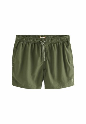 Costume da bagno verde con cintura elasticizzata, dettaglio con cordoncino e tasche laterali. Texture liscia e design a vestibilità rilassata.