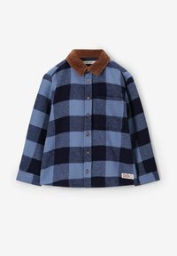 Blauwe en marineblauwe geruite blouse met een bruine fluwelen kraag, lange mouwen en een borstzak. Voorzien van een knoopsluiting en een gestructureerde stof.