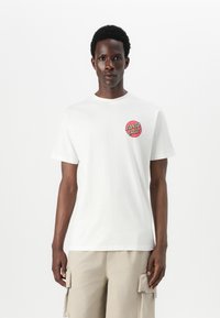 White cotton t-shirt with round neckline, short sleeves, and a red circular "SANTA CRUZ" logo on the left chest.