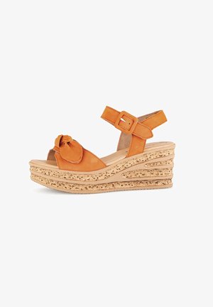 Orange wedge sandals with a knotted front detail, adjustable ankle strap, and a textured cork-like platform. Smooth leather material.