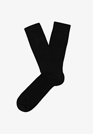 Black ribbed socks with a solid pattern, featuring a reinforced cuff and toe areas for durability.