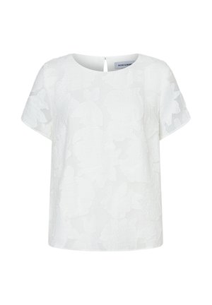 Blouse blanche à manches courtes avec un motif floral texturé subtil, encolure ronde et fermeture au dos avec un bouton sur une fente en forme de goutte.