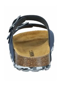 Navy sandal with wide, crossed straps, a cork footbed, and a patterned sole. Rear view highlights textural details and construction style.