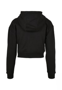 Hoodie court noir vu de dos avec manches longues, poignets côtelés et capuche.