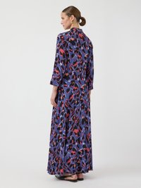 Maxi dress in smooth fabric featuring a purple, black, and red leopard print, long sleeves, and a high neckline.