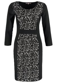 Svart klänning med långa ärmar med en spetsöverdrag i vita blommönster, slät tyg och rundad halsringning.