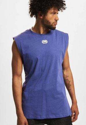 Sleeveless purple cotton t-shirt with a round neckline and a small white logo on the chest. Smooth texture and relaxed fit.
