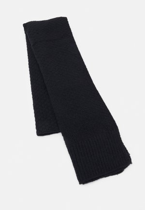 Écharpe noire tricotée pliée à plat, présentant des bords côtelés et un motif tricoté texturé sur un côté.