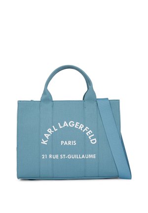 Borsa tote di tessuto blu con manici doppi e tracolla regolabile. Presenta il testo frontale: "KARL LAGERFELD PARIS 21 RUE ST-GUILLAUME." Il testo è di colore bianco.