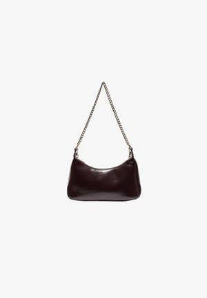 Small dark brown leather handbag with a gold chain strap hanging against a white background.