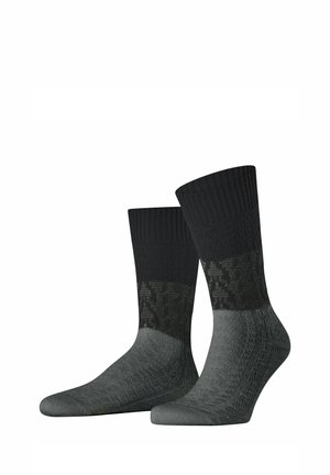 Pair of black and dark gray crew socks with patterned knit texture, standing upright against a white background.