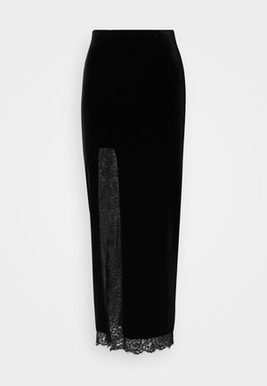 Melnas samta svārki ar caurspīdīgu mežģīņu paneļa vienā pusē, izgriezumu un mežģīņu apdari ap apakšējo malu. Pielāgota forma ar gludu tekstūru.