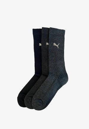 Set of three pairs of socks in dark navy, black, and charcoal gray. Ribbed texture with a small white logo on the side.
