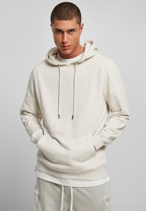 Ensfarget beige hettegenser med snøring på hetta, frontlomme, lange ermer og en avslappet passform. Myk tekstur og minimalistisk design.