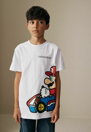 White cotton t-shirt featuring a large printed graphic of a cartoon character in a go-kart, with black, red, and blue accents.