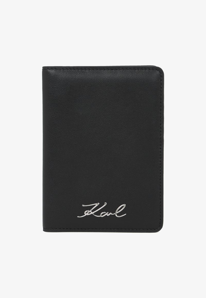 Μαύρο δίπτυχο δερμάτινο πορτοφόλι με λείο υφή και ασημένια υπογραφή "Karl" στην κάτω δεξιά γωνία της μπροστινής πλευράς.