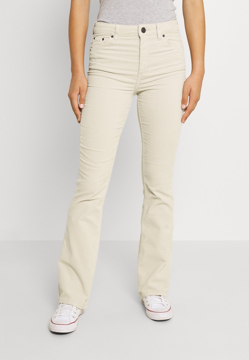 Beiga raka jeans i bomullsmaterial med medelhög midja, knappstängning och lätt stretch för komfort.