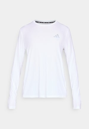 Fehér, hosszú ujjú sportfelső nedvességelvezető anyagból. Kerek nyakkivágással és finom, szürke háromcsíkos logóval a mellkasán.