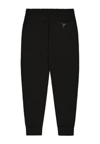 Zwarte joggingsbroek met een elastische tailleband, taps toelopende pijpen en cuffed hems. Bevat een klein logodetail op de achterkant. Glad textuur.