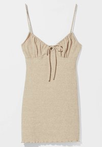 Robe en tricot beige avec des bretelles spaghetti réglables, un bustier froncé avec un détail à nouer et une silhouette ajustée. Tissu à motif côtelé.