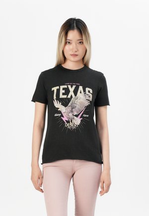 Black cotton t-shirt featuring a graphic design with “Texas,” an eagle, and lightning accents in pink and cream. Round neckline, short sleeves.
